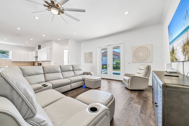 living room with dark wood-type flooring, ceiling fan, and french doors