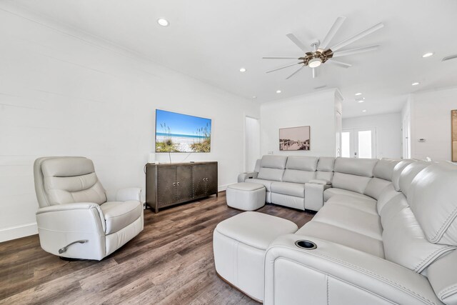 living room featuring crown molding, ceiling fan, and dark hardwood / wood-style floors