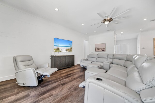 living room with ceiling fan, dark hardwood / wood-style floors, and ornamental molding