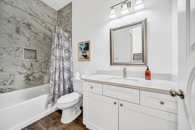 full bathroom featuring shower / bathtub combination with curtain, toilet, hardwood / wood-style flooring, and vanity