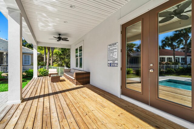 wooden terrace with outdoor lounge area and ceiling fan