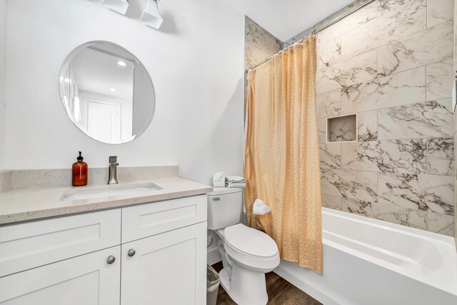 full bathroom featuring vanity, toilet, hardwood / wood-style flooring, and shower / bathtub combination with curtain