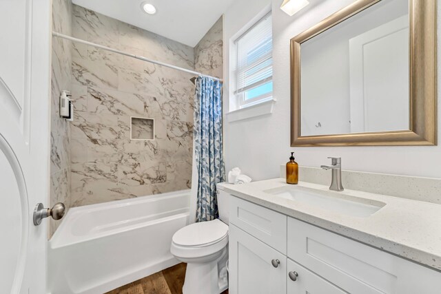 full bathroom with shower / bath combo with shower curtain, toilet, hardwood / wood-style flooring, and vanity