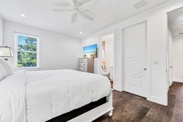 bedroom with connected bathroom, ceiling fan, and dark hardwood / wood-style floors