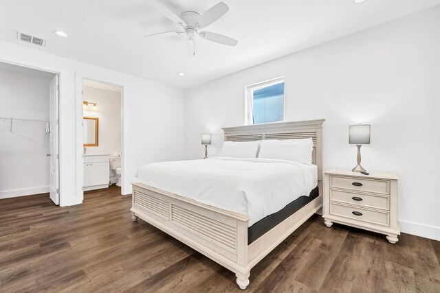 bedroom featuring connected bathroom, ceiling fan, a closet, dark hardwood / wood-style floors, and a walk in closet