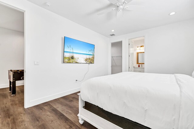 bedroom featuring a walk in closet, ceiling fan, dark hardwood / wood-style floors, and a closet