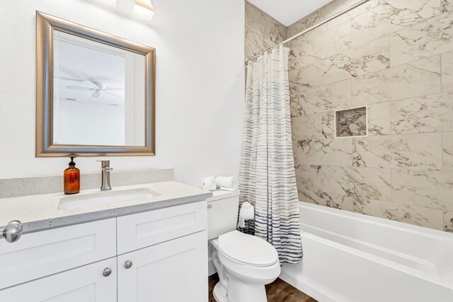 full bathroom featuring vanity, toilet, wood-type flooring, and shower / bathtub combination with curtain