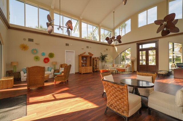 dining space featuring a wealth of natural light, hardwood / wood-style floors, and high vaulted ceiling