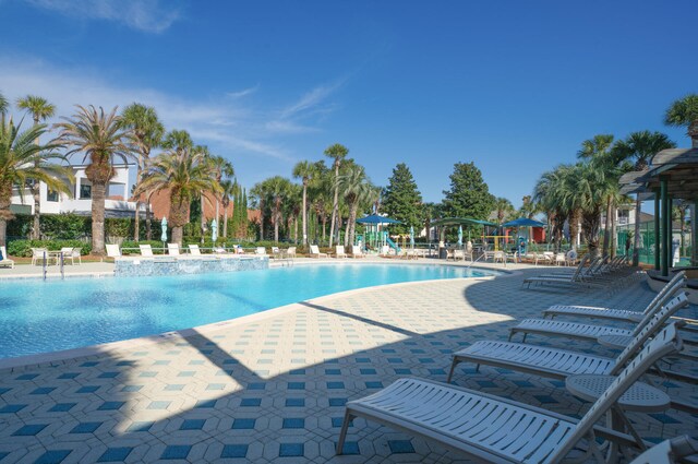 view of swimming pool featuring a playground