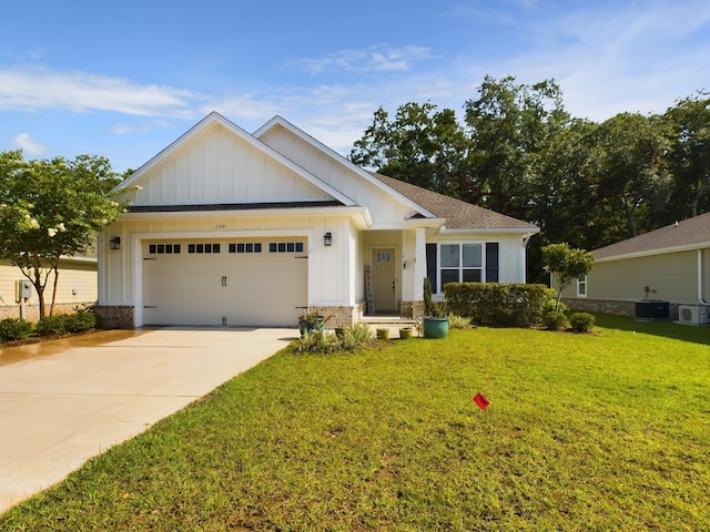 craftsman-style home featuring cooling unit, a garage, and a front yard