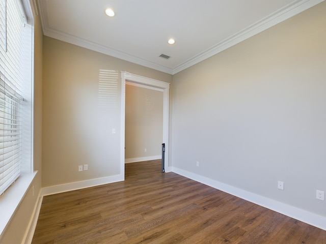 empty room with ornamental molding and dark wood-type flooring