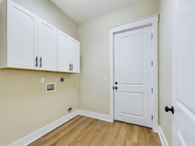 laundry room with washer hookup, electric dryer hookup, light hardwood / wood-style floors, and cabinets