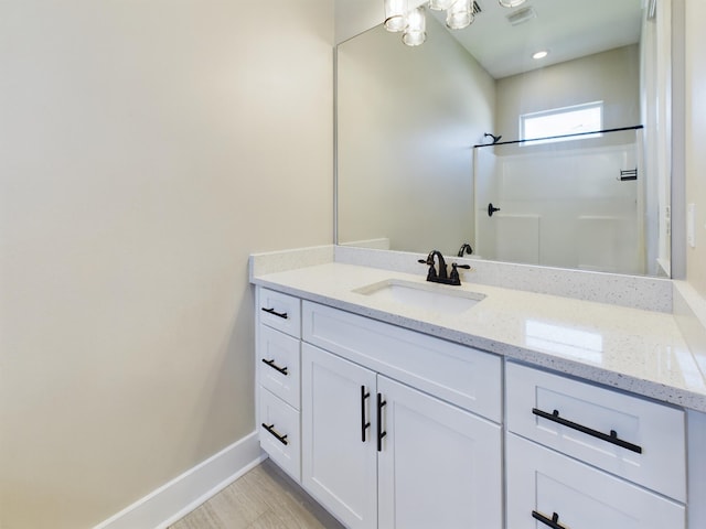 bathroom with vanity and walk in shower