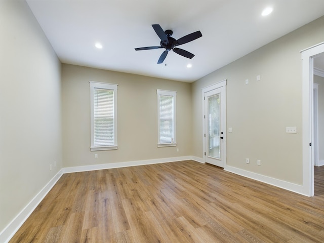 spare room featuring ceiling fan and light hardwood / wood-style flooring