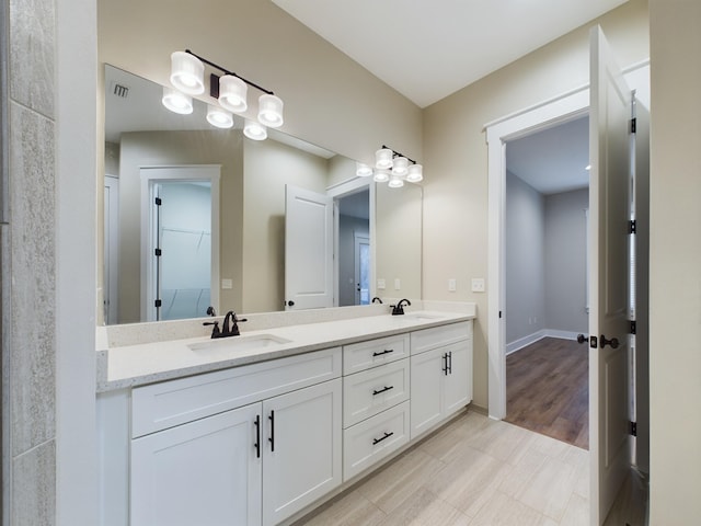 bathroom featuring hardwood / wood-style flooring and vanity