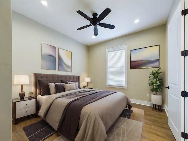 bedroom with hardwood / wood-style floors and ceiling fan