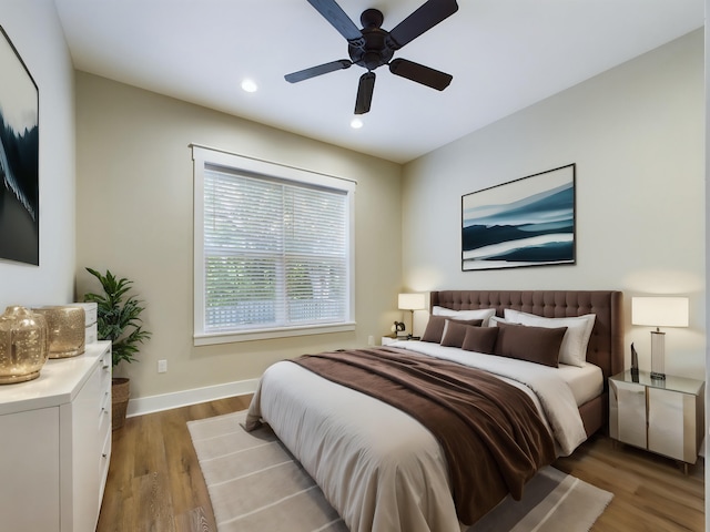 bedroom with light hardwood / wood-style flooring and ceiling fan