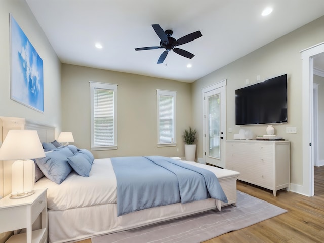 bedroom with light hardwood / wood-style flooring and ceiling fan