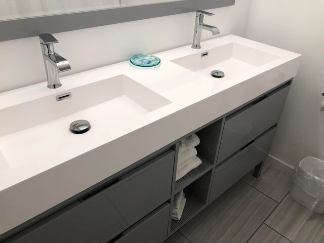 bathroom with vanity and tile flooring