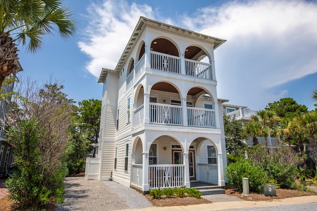 mediterranean / spanish home featuring a porch and a balcony