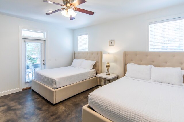 bedroom featuring ceiling fan, access to exterior, and multiple windows