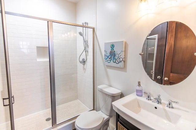 bathroom with vanity, a shower with shower door, and toilet