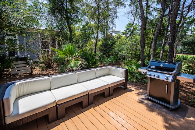 wooden terrace with outdoor lounge area and grilling area