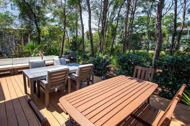 wooden terrace featuring outdoor lounge area and area for grilling