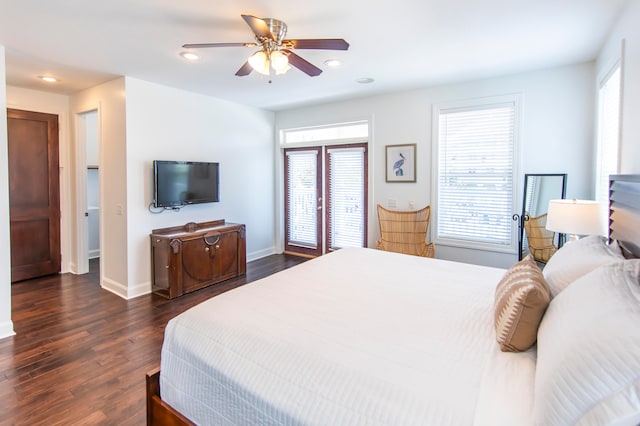 bedroom with ceiling fan, dark hardwood / wood-style flooring, and multiple windows