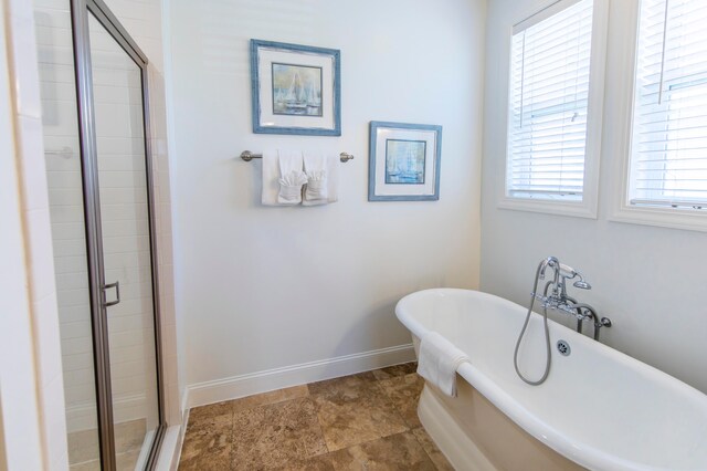 bathroom with tile flooring and separate shower and tub