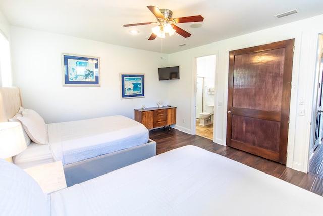 bedroom with dark wood-type flooring, ceiling fan, and ensuite bathroom