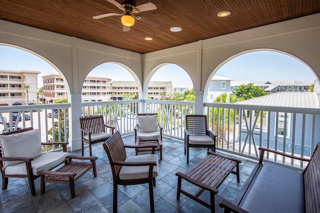 view of patio with a balcony and ceiling fan