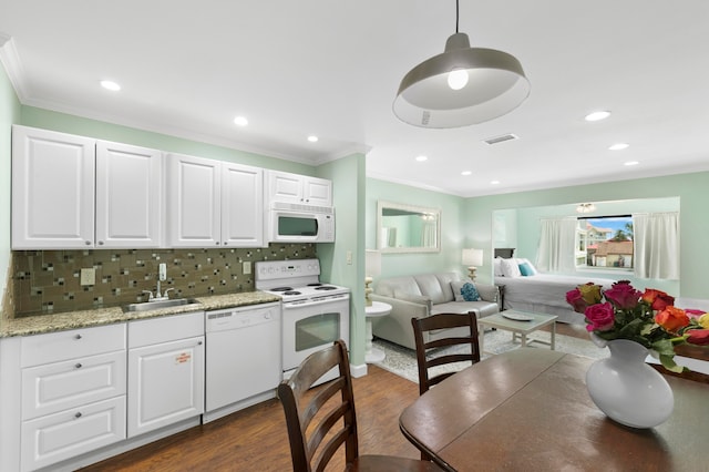 kitchen featuring sink, white appliances, backsplash, white cabinetry, and dark hardwood / wood-style flooring