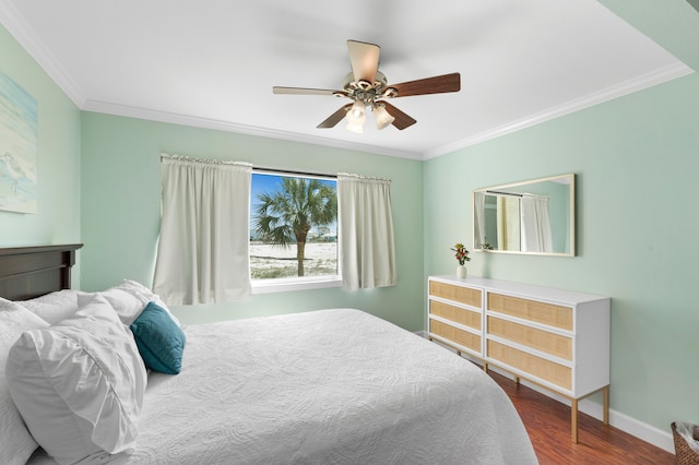 bedroom featuring dark hardwood / wood-style flooring, ceiling fan, and crown molding