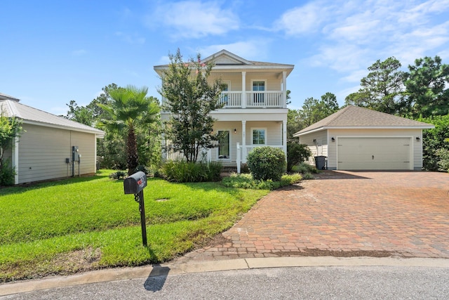 view of front facade featuring a front lawn, a garage, and a balcony