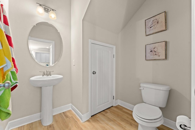 bathroom featuring hardwood / wood-style floors and toilet