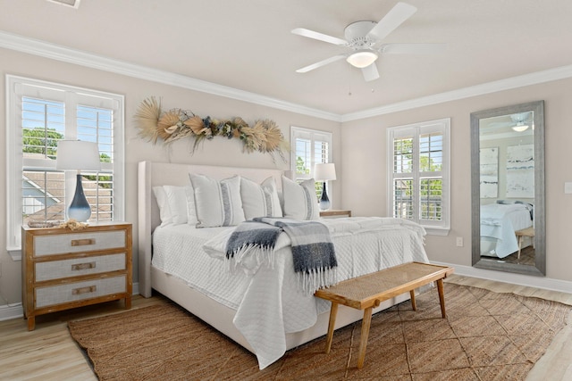 bedroom with ornamental molding, ceiling fan, and hardwood / wood-style flooring