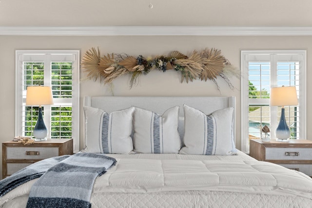 bedroom featuring ornamental molding and multiple windows