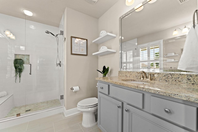 bathroom with oversized vanity, a shower with shower door, tile floors, and toilet