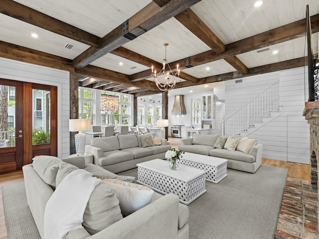 living area featuring wood walls, a chandelier, beamed ceiling, wood finished floors, and recessed lighting