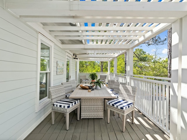 deck with outdoor dining area and a pergola