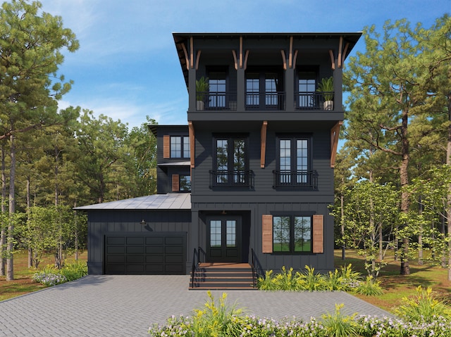 view of front of property with a garage and a balcony