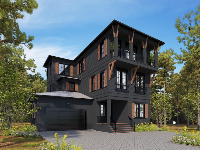 view of front of house with a garage and a balcony