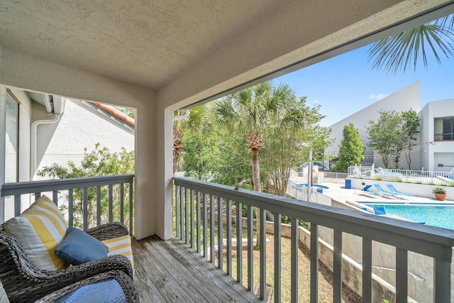 balcony featuring a fenced in pool