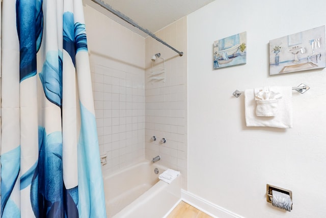 bathroom with shower / bathtub combination with curtain and hardwood / wood-style floors