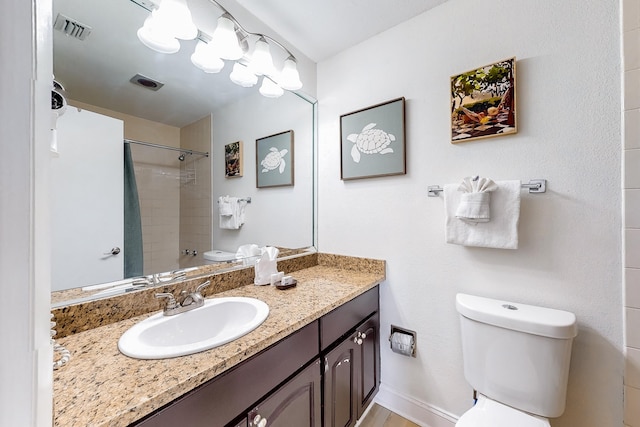 bathroom with vanity with extensive cabinet space and toilet