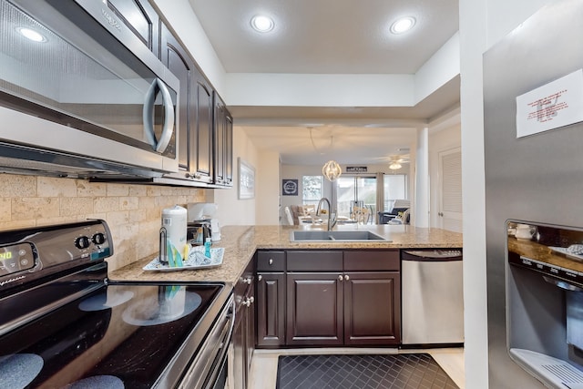 kitchen featuring dark brown cabinetry, appliances with stainless steel finishes, tile flooring, sink, and ceiling fan