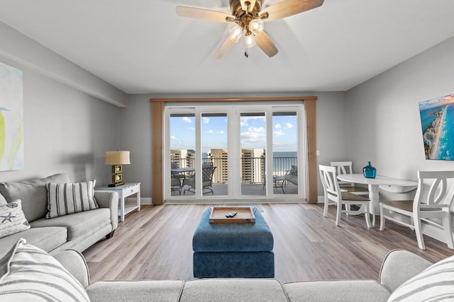 living room featuring ceiling fan and light wood-type flooring