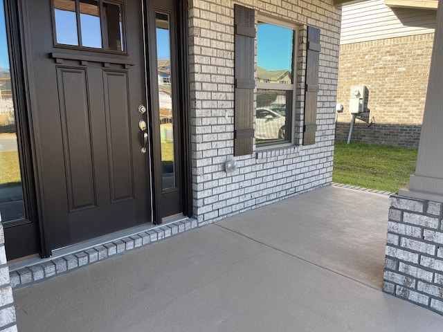 property entrance with a patio area