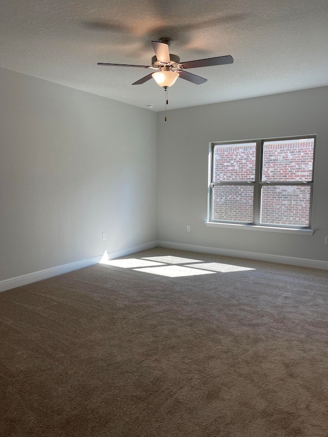 carpeted empty room with a textured ceiling and ceiling fan